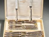 silverware in a wooden box with two knives and a knife sharper