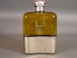 a bottle of perfume sitting on a table on a white surface