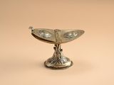 a silver plate with a bird on top of it