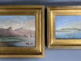 two framed paintings of boats on the water and a mountain in the distance