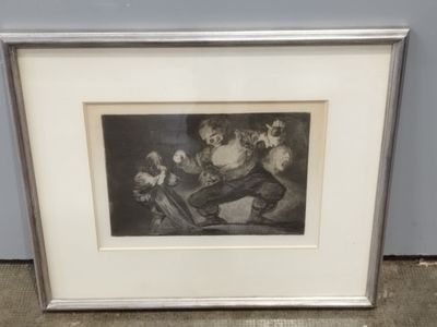 an old picture of a man sitting on a chair with a dog