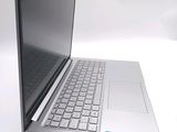 a silver laptop computer sitting on top of a white table