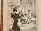 someone is holding an open book with a drawing of a woman walking down the street