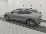 a gray car is parked in a garage with a black and white checkered floor
