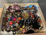 a box full of assorted jewelry on a table