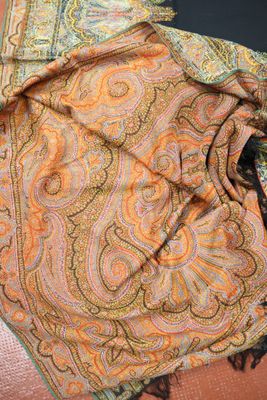 a close up picture of a scarf on a chair