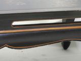 a close up of a black table with a wooden top