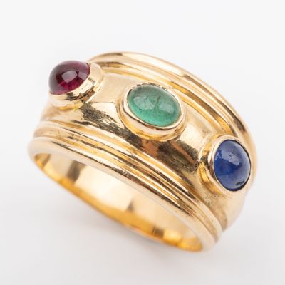 an image of a gold ring with three different colored stones