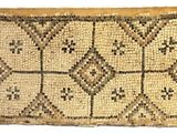a close up of a woven rug on a white surface