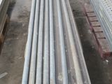 a lot of steel pipes that are stacked on top of each other