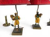 two lamps that are on a table with a red shade