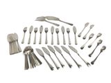 a lot of forks and spoons that are on the table