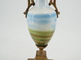 a blue and white vase sitting on a wooden stand