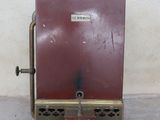 a small red machine that is sitting on the ground