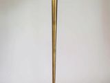 a tall brass table with a marble top on a wooden base