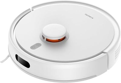 a close up of a robot vacuum cleaner on a white surface