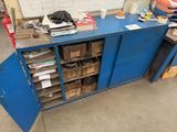 a blue cabinet that has a bunch of boxes on top of it