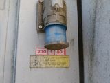 a close up of a water meter on the side of a building