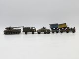 four toy vehicles that are lined up on a white surface