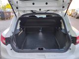a trunk of a white car with its doors open