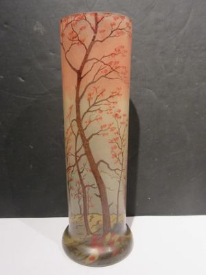 a glass vase with a painting of a tree on it