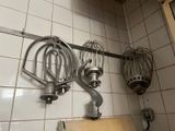 a bunch of kitchen utensils hanging on the wall