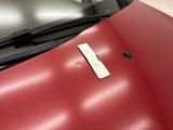 a close up of a car ' s hood with a remote control