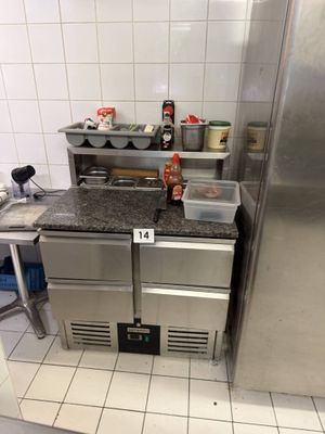 a kitchen with a refrigerator, stove, sink and counter top