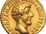 a gold coin with a head of a man on it
