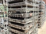 a large pile of scaffolding sitting on top of a dirt field