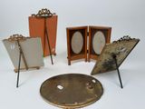 four different sized picture frames and a mirror on a white surface