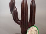 a wooden cactus plant with a clock on it