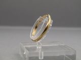 an image of a gold ring on a clear stand