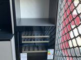 a wine cooler in the corner of a kitchen