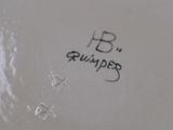the bottom of a white plate with a black writing on it
