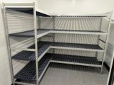 many shelves that are in the corner of a room