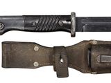 a knife that is laying on top of a leather case