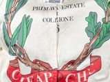 a close up of a white jacket with a red ribbon on it