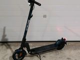 a scooter that is parked in front of a garage door