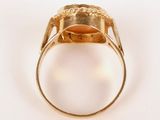 an image of a gold ring with an oval stone in the center