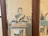 pair of framed asian paintings of a man and a woman sitting at a table
