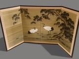 two birds that are standing in a room together