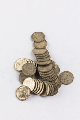 pile of old coins on a white background
