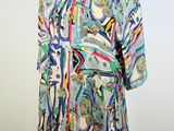an image of a dress on a mannequin stand with a white background