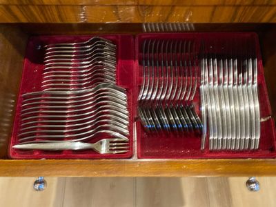 many forks and spoons in a wooden drawer