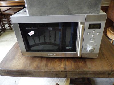 a microwave sitting on top of a wooden table