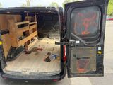 a black van with a television in the back of it