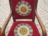 a red chair with a floral design on the back
