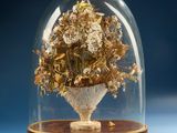 a glass dome with a bunch of flowers inside of it