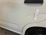 a white car with a sticker on the side of it ' s door